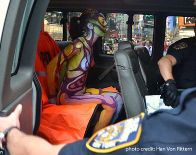 Zoe West, who began her modeling career working for me in Book of Blue, in police custody for being painted and nude in Times Square. The charges were dismissed -- it was legal conduct. The City of New York had to pay her $15,000 damages. Photo by Harry Rittern.